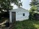 Old, weathered garage exterior showing a single window with some overgrown foliage at 1226 Hiatt St, Indianapolis, IN 46221