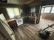 Shows an unkept kitchen with poor lighting, dated cabinets, and peeling floor at 1226 Hiatt St, Indianapolis, IN 46221