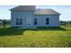 Rear elevation of home features siding, windows, patio, and lawn at 1328 Plover Dr, Greenwood, IN 46143