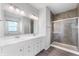 Elegant bathroom features a double sink vanity, large mirror, and a glass-enclosed shower at 1328 Plover Dr, Greenwood, IN 46143