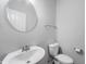 Contemporary bathroom featuring a sleek round mirror and modern fixtures for a clean, minimalist aesthetic at 1328 Plover Dr, Greenwood, IN 46143