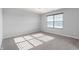 Bright bedroom features neutral carpeting, gray walls, and a window with blinds at 1328 Plover Dr, Greenwood, IN 46143
