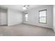 Spacious bedroom with neutral walls, plush carpeting, and a ceiling fan with stylish light fixture at 1328 Plover Dr, Greenwood, IN 46143