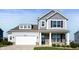 Charming two-story home featuring a two-car garage and a welcoming front porch at 1328 Plover Dr, Greenwood, IN 46143