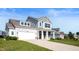 Well-maintained two-story home with a spacious driveway and a neatly landscaped front yard at 1328 Plover Dr, Greenwood, IN 46143