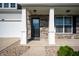 Inviting front porch with stone pillars and a decorative front door at 1328 Plover Dr, Greenwood, IN 46143