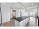 Bright kitchen with island, stainless steel appliances, and an open layout to the dining area at 1328 Plover Dr, Greenwood, IN 46143