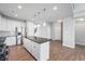 Spacious kitchen featuring a central island, stainless steel refrigerator, and modern lighting at 1328 Plover Dr, Greenwood, IN 46143