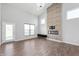Spacious living room featuring a stone fireplace, tall ceilings, and large windows for abundant natural light at 1328 Plover Dr, Greenwood, IN 46143