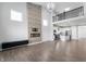 Living area with wood-look flooring and stone fireplace with an open floorplan to the kitchen and dining room at 1328 Plover Dr, Greenwood, IN 46143