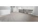 A loft area features a dark wood railing with neutral plush carpet throughout at 1328 Plover Dr, Greenwood, IN 46143