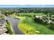 Aerial view showcases a community near a well-manicured golf course and a serene lake at 15410 Mission Hills Dr, Carmel, IN 46033