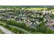 Aerial view featuring a residential community with ponds, mature trees, and green spaces at 15410 Mission Hills Dr, Carmel, IN 46033