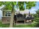 View of the back deck with black railings from the yard, with grill and patio furniture at 15410 Mission Hills Dr, Carmel, IN 46033