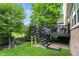 Enjoy backyard views from the elevated back deck with black railings and outdoor furniture at 15410 Mission Hills Dr, Carmel, IN 46033