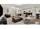 Finished basement includes a large sectional sofa, game tables, and stairs leading to the upper level at 15410 Mission Hills Dr, Carmel, IN 46033