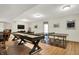 Finished basement featuring game tables including ping pong and shuffleboard for leisure and recreation at 15410 Mission Hills Dr, Carmel, IN 46033