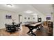 Spacious finished basement with a game room, shuffleboard, ping pong, and bar area for entertaining at 15410 Mission Hills Dr, Carmel, IN 46033