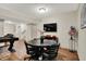 Basement featuring hardwood-style floors, a table with chairs, and a TV for entertainment at 15410 Mission Hills Dr, Carmel, IN 46033