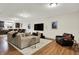 Finished basement with a comfortable seating area, hardwood floors, and a modern entertainment center at 15410 Mission Hills Dr, Carmel, IN 46033
