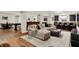 Open basement featuring a lounge area, bar with seating, and wood-look flooring, perfect for entertaining at 15410 Mission Hills Dr, Carmel, IN 46033