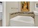 Bathroom features a soaking tub, artwork, and tile surround at 15410 Mission Hills Dr, Carmel, IN 46033