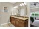 Bright bathroom features a double vanity with granite countertops and ample lighting at 15410 Mission Hills Dr, Carmel, IN 46033