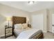 Well-lit bedroom features neutral paint, carpet, furniture, lamps, and a closet for storage at 15410 Mission Hills Dr, Carmel, IN 46033