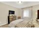 Inviting bedroom featuring a dresser with TV and window with blinds at 15410 Mission Hills Dr, Carmel, IN 46033