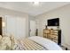 Comfortable bedroom with rustic wood dresser and mounted TV at 15410 Mission Hills Dr, Carmel, IN 46033