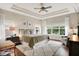 Spacious bedroom with tray ceiling, ceiling fan, large windows, and hardwood flooring at 15410 Mission Hills Dr, Carmel, IN 46033