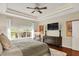 Cozy bedroom offers a ceiling fan, large windows, artwork, and hardwood flooring at 15410 Mission Hills Dr, Carmel, IN 46033