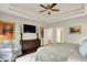 Spacious bedroom offers a ceiling fan, artwork, dresser, and hardwood flooring at 15410 Mission Hills Dr, Carmel, IN 46033
