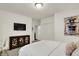 Bedroom featuring a modern cabinet, mounted TV, and stylish decor at 15410 Mission Hills Dr, Carmel, IN 46033