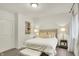 Comfortable bedroom with tufted headboard, stylish lamps, and soft decor at 15410 Mission Hills Dr, Carmel, IN 46033