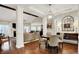 Open-concept dining area with hardwood floors and view into the living room at 15410 Mission Hills Dr, Carmel, IN 46033