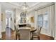 Dining area with hardwood floors, stylish lighting fixture, and large window at 15410 Mission Hills Dr, Carmel, IN 46033