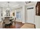 Dining area featuring hardwood floors, decorative lighting, and a neutral color palette at 15410 Mission Hills Dr, Carmel, IN 46033