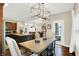 Dining room with a view of the kitchen and living area, a chandelier, and a dining table with seating for six at 15410 Mission Hills Dr, Carmel, IN 46033