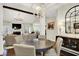 Open-concept dining room featuring a round table and views into the stylish living area with fireplace at 15410 Mission Hills Dr, Carmel, IN 46033
