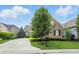 Brick home with a well-manicured lawn and landscaping at 15410 Mission Hills Dr, Carmel, IN 46033