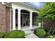 Inviting front porch framed by white pillars and lush greenery at 15410 Mission Hills Dr, Carmel, IN 46033