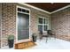 Welcoming front porch features brick accents and seating area at 15410 Mission Hills Dr, Carmel, IN 46033
