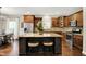 Modern kitchen with granite countertops, stainless steel appliances, and a central island at 15410 Mission Hills Dr, Carmel, IN 46033