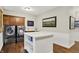 Laundry room with modern washer, dryer, and custom cabinets offering ample storage space at 15410 Mission Hills Dr, Carmel, IN 46033