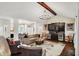 Open living space with a bar, fireplace, and view into the adjacent dining and living areas at 15410 Mission Hills Dr, Carmel, IN 46033