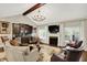 Inviting living room featuring a fireplace, vaulted ceiling, and a stylish built-in bar at 15410 Mission Hills Dr, Carmel, IN 46033