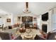 Bright living room showcasing a fireplace, custom wet bar, and an open floor plan at 15410 Mission Hills Dr, Carmel, IN 46033