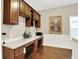 A home office featuring beautiful hardwood floors, built-in cabinets, and ample workspace at 15410 Mission Hills Dr, Carmel, IN 46033