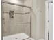 Modern walk-in shower features sleek glass doors and a tiled niche for storage at 15410 Mission Hills Dr, Carmel, IN 46033